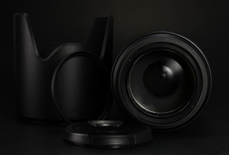 Camera lens, filter, hood and lens cap  on black backgroundの写真素材