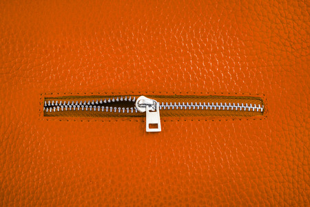 Rust color leather with unlocked zipper.の写真素材
