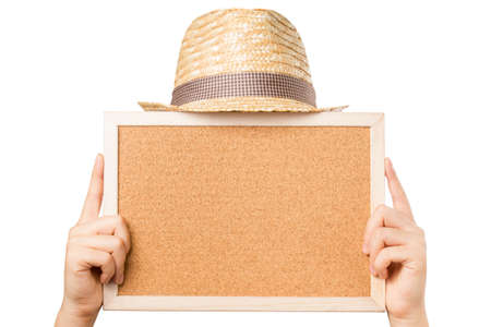 Hand holding cork board and hat isolated on white background. Include clipping path.の写真素材