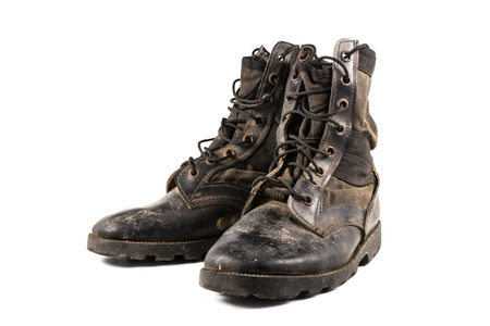 A pair of old combat boots isolated on white background.の写真素材