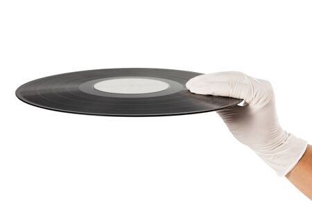 Hand with glove holding black vinyl record disc isolated on white background.の写真素材
