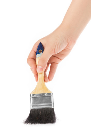 Hand holding paint brush isolated on white background.の写真素材