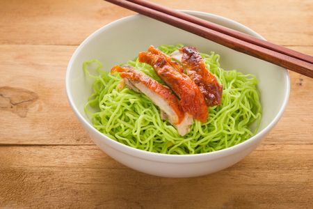 Roasted duck with green jade noodles on wooden table.の写真素材