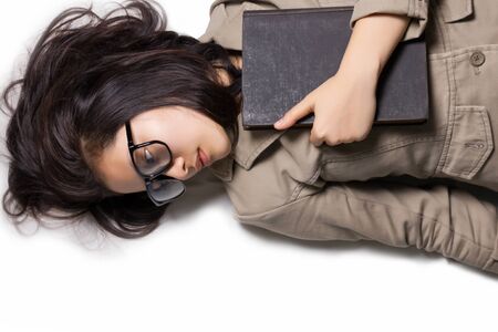 Top view of designer woman with glasses and book laying on the floor.の写真素材