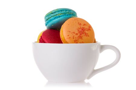 Close up colorful macaroons in the cup isolated on white background.の写真素材