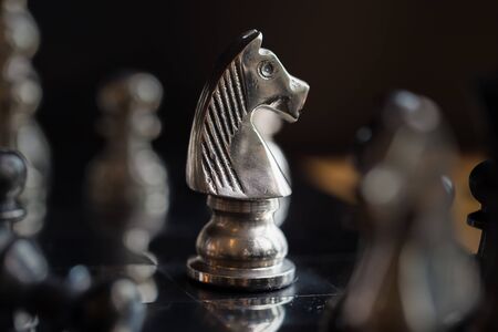 King and Knight of chess setup on dark background . Leader and teamwork concept for success. Chess...