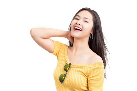 Young happy Asian woman with smiley wearing nice yellow dress isolated on white