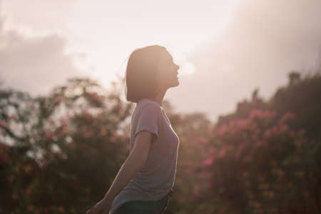 Young woman relaxing in summer sunset sky outdoor camping. People freedom style.の写真素材