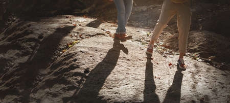 Happy couple hiking outdoors in forest. Active young Asian woman and man holding hand walking in the...