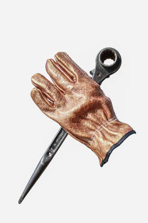 wrench with glove on white backgroundの写真素材