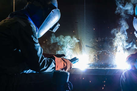 Welding work during night time with friendsの写真素材