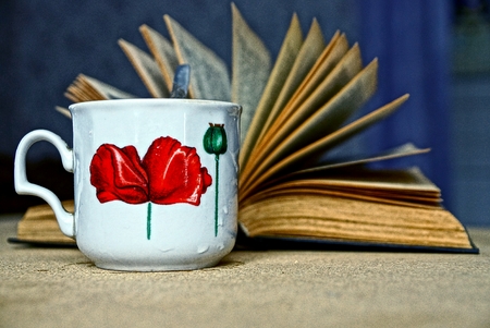 A cup of tea and an open bookの写真素材