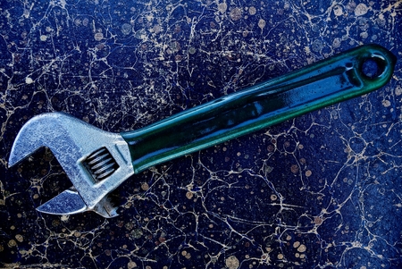 Adjustable wrench on a gray, shabby backgroundの写真素材