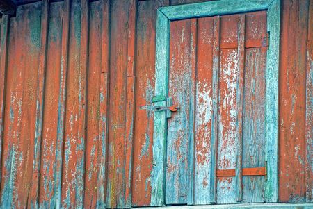 The old door on the red wooden wallの写真素材