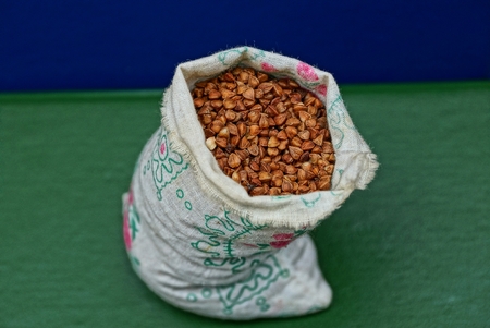 a little sack of buckwheat on the green surfaceの写真素材