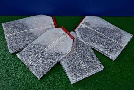 A set of white tea bags with black teaの写真素材