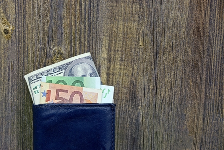 Wallet and currency on a gray wooden backgroundの写真素材