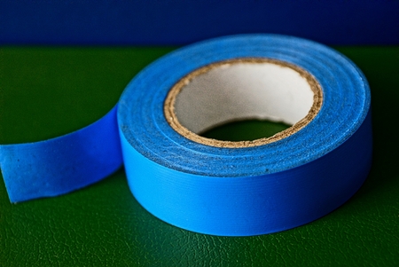 Blue industrial insulating tape on a green surfaceの写真素材