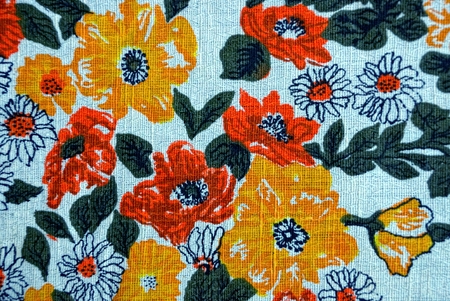 Texture of a fabric with a pattern and flowers on a piece of cloth
