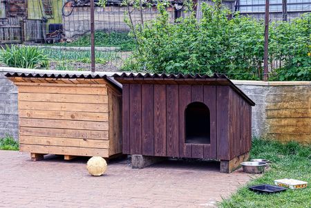 Two wooden dog kennels in the yardの写真素材