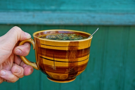 Cup with tea in handの写真素材