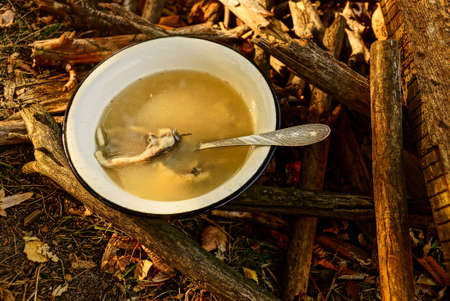 Soup in the Iron Bowl on the grounds near ash fireの写真素材
