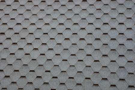 Texture of gray shingles on the roof of the house