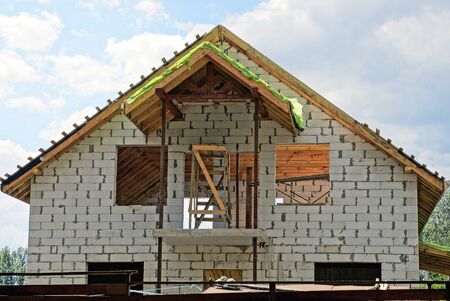 Building a white brick house against the sky and cloudsの写真素材