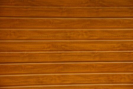 Brown background of wooden fence boards on the street
