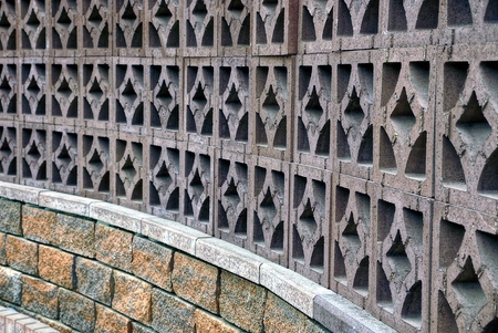 Beautiful stone fence with a pattern and bricks