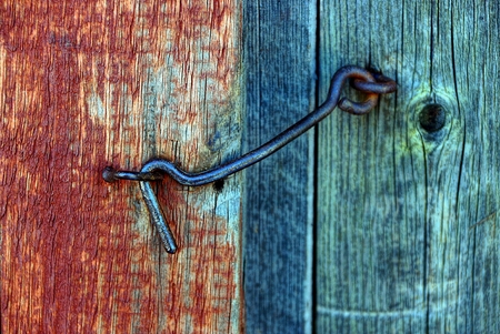 Iron old hook latch in a loop on an old wooden doorの写真素材