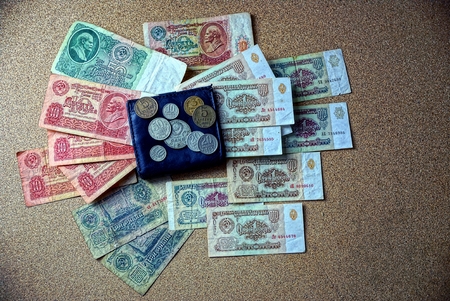 Black purse on the table with coins and billsの写真素材