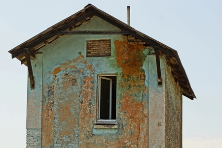 Facade of an old house with an open window on a sky backgroundの写真素材