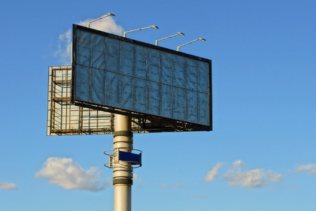Large billboard on the pipe against the sky and cloudsの写真素材