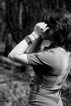 The girl smoothes her glasses with her handの写真素材