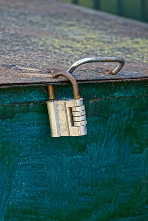 Code padlock on an old iron tank
