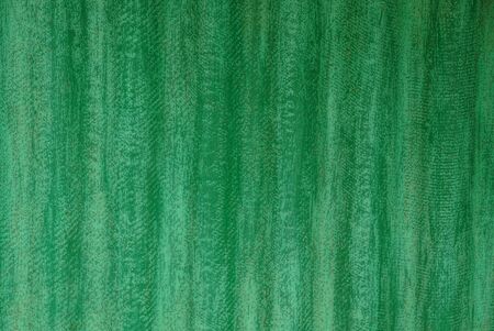 Background of a grated old green iron wall of a private buildingの写真素材