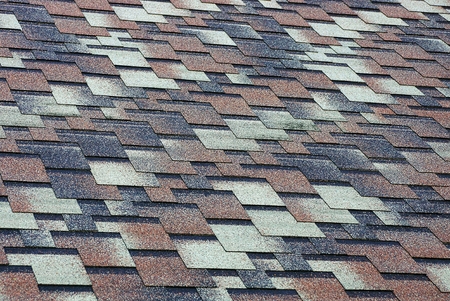 Colored texture of a fragment of a roofing tile on the roof of the house