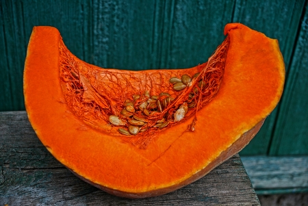 piece of red pumpkin by the green wallの写真素材