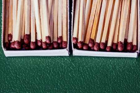 many matches in paper boxes on a green surfaceの写真素材