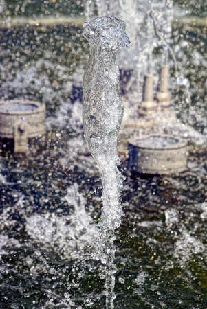 drops and splashes from the transparent water of a city fountainの写真素材
