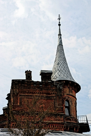 Part of the roof of the old house against the sky and cloudsのeditorial素材