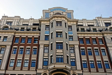Beautiful multi-storey house with windows and balconies on the sky