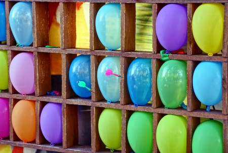 Darts of colored inflatable balls on the shelfの写真素材