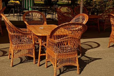 Wicker brown table and chairs on the asphaltの写真素材