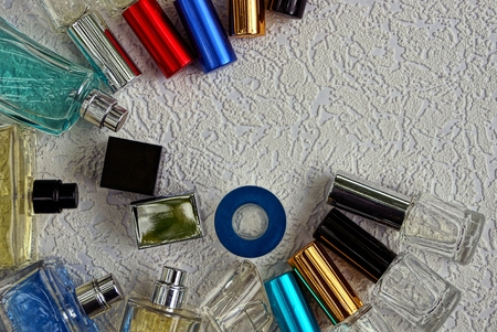 glass bottles with colored perfume on a white surface