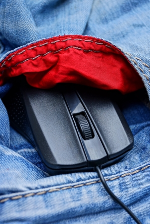black computer mouse in the pocket of blue trousers and red lining