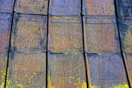 old rusty iron sheets on the roof of the buildingの写真素材