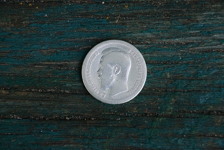 old silver russian coin on a wooden boardの写真素材
