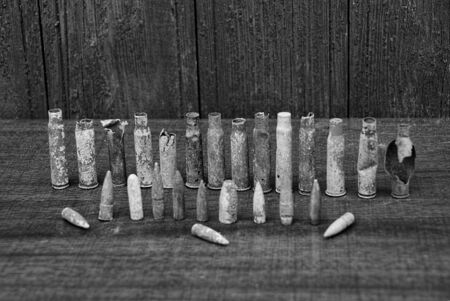 rows of old casings and bullets on a gray tableの写真素材